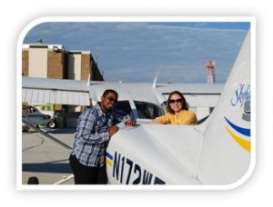 Instructor and student standing by plane